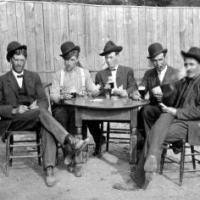 Albert Pauly, John Roeser, Bill Pauly, Frank Lenardo and unidentified  person playing cards. circa 1915