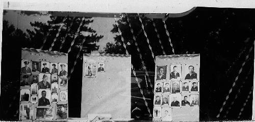 WWII photos of service men on display at Pauly's store - 1945