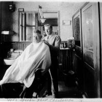 Joe Meuwissen, barber.  Jacob Jeurissen is the patron - Circa 1927