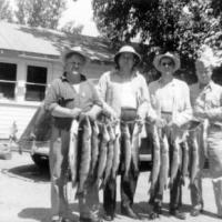 Fisherman with catch at Leach's Resort on Lake Minnewashta. circa 1950