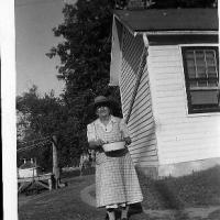 Elizabeth (Schlenk) Rettler standing in the back of her home - circa early 1950's